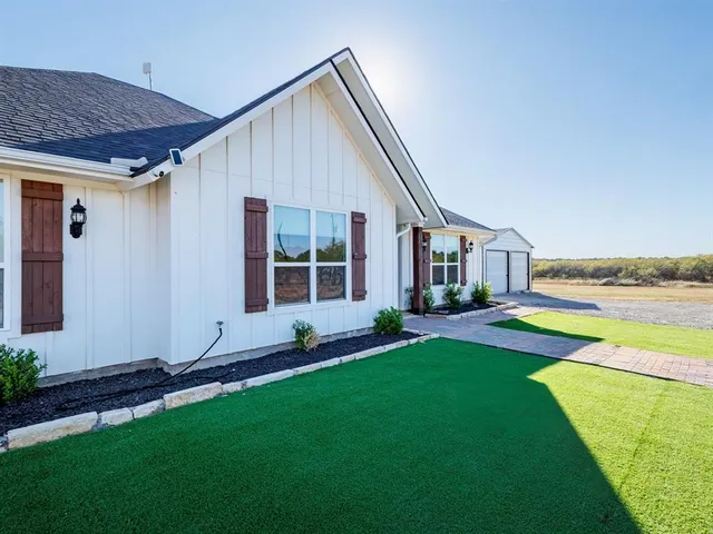 a house view with a garden and deck