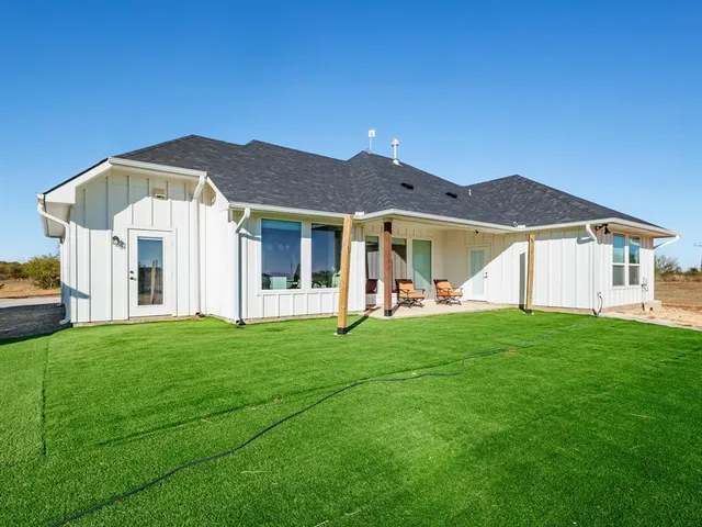 a view of a house with a backyard