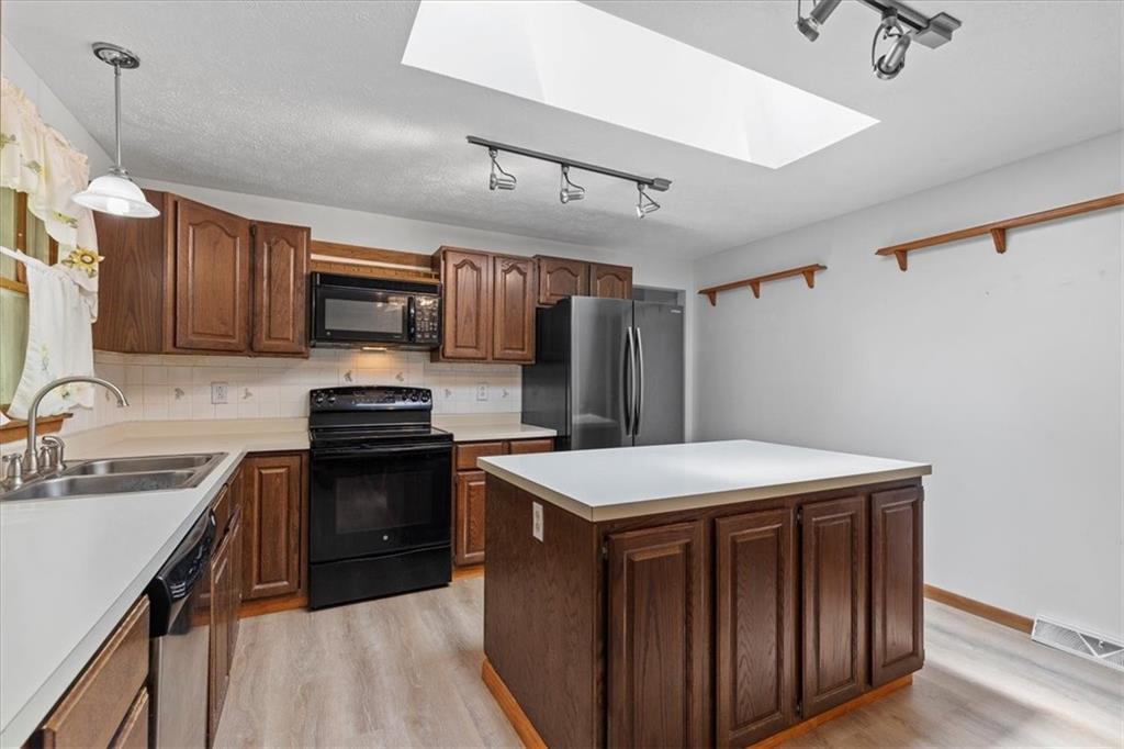 347 Lee Road Burgettstown, PA 15021 - Photo 12 of 48 a kitchen with sink a microwave and refrigerator