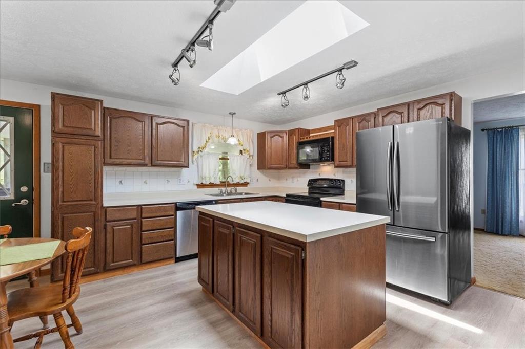 347 Lee Road Burgettstown, PA 15021 - Photo 13 of 48 a kitchen with kitchen island granite countertop stainless steel appliances cabinets a sink and a counter top space