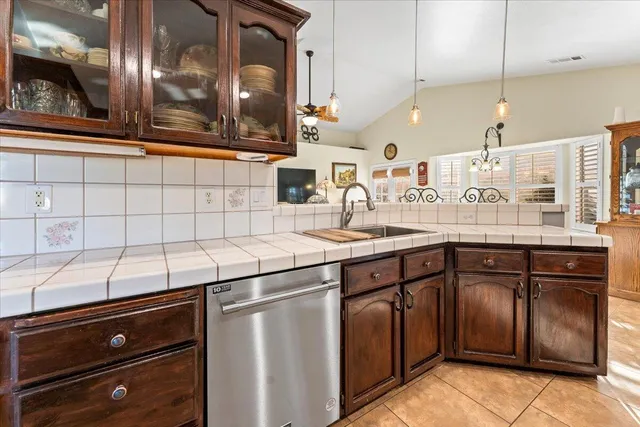 a view of a room with kitchen island stainless steel appliances wooden floor and living room view
