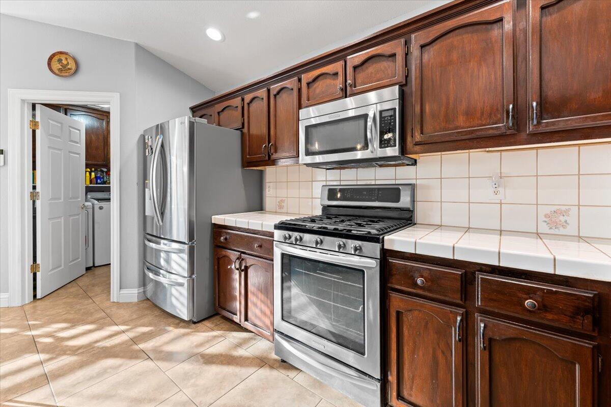 2995 Howard Drive Redding, CA 96001 - Photo 17 of 57 a kitchen with stainless steel appliances granite countertop a stove microwave and refrigerator