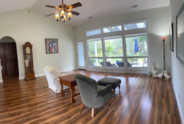 a living room with furniture and a wooden floor