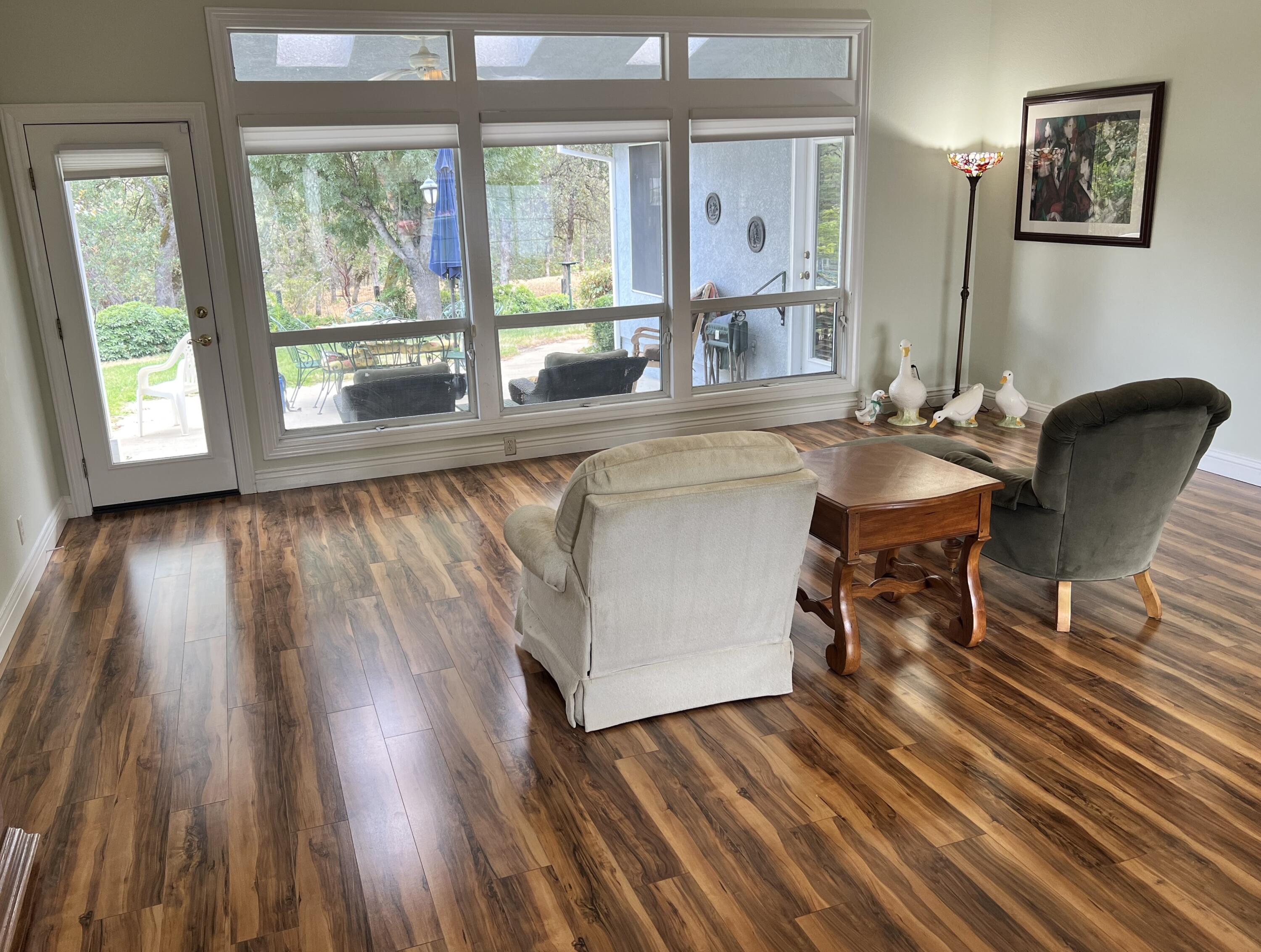 2995 Howard Drive Redding, CA 96001 - Photo 8 of 57 a dining room with wooden floor and a floor to ceiling window
