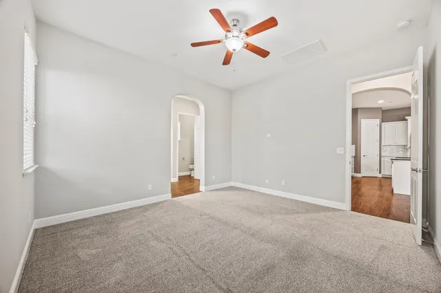 an empty room with closet and fan