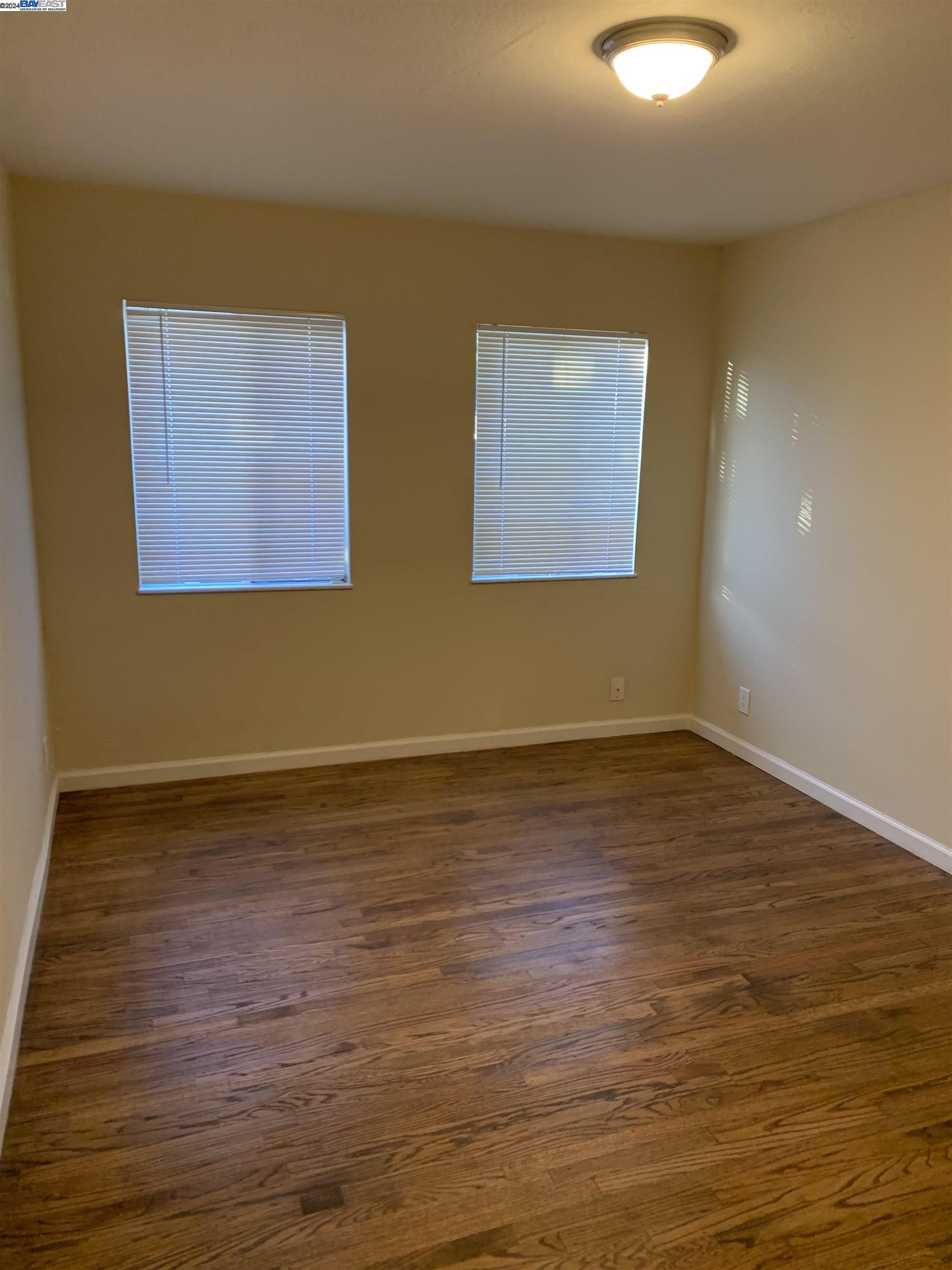 26730 Tyrrell Avenue Hayward, CA 94544 - Photo 11 of 26 a view of an empty room with wooden floor and a window