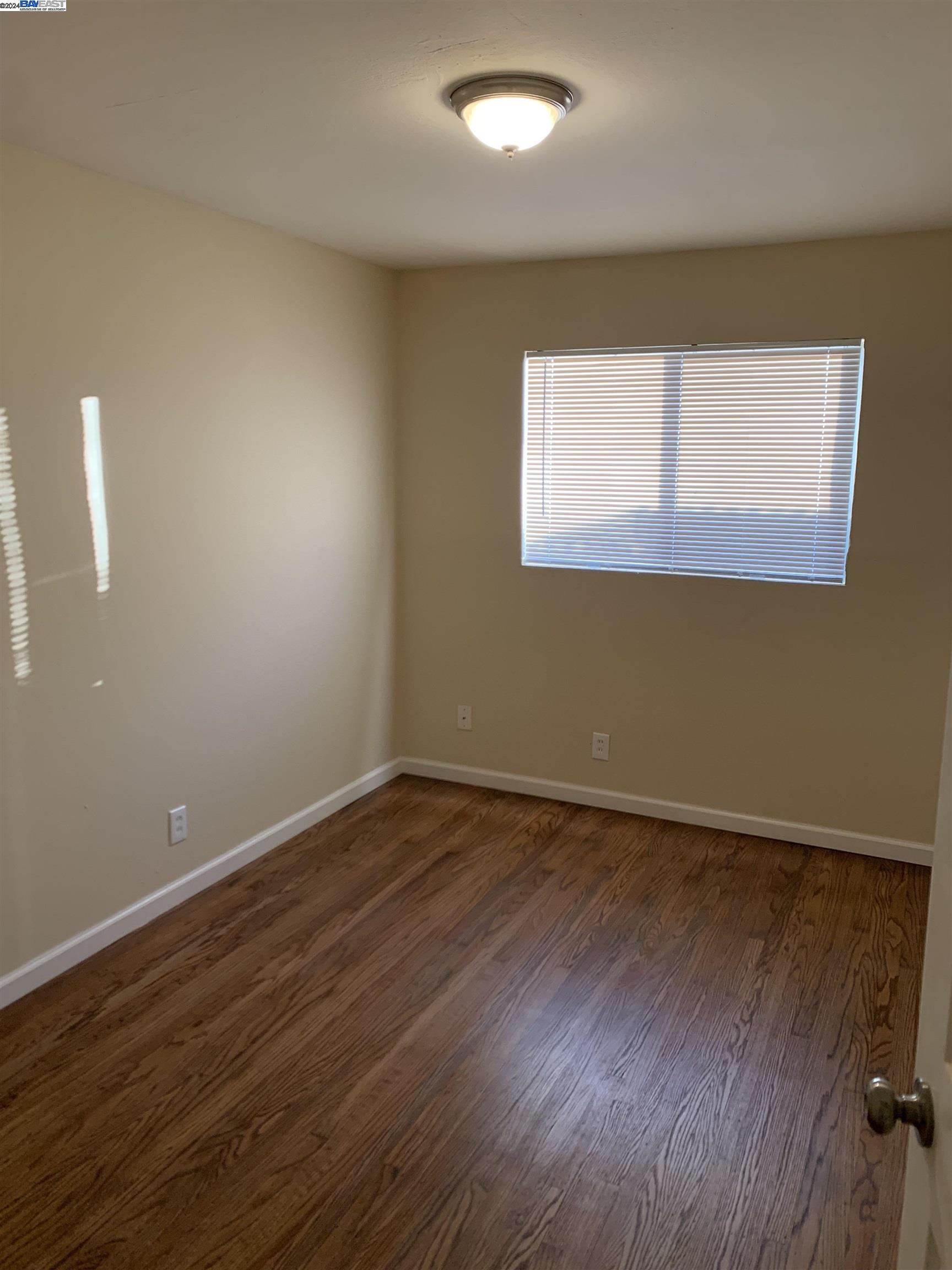 26730 Tyrrell Avenue Hayward, CA 94544 - Photo 13 of 26 an empty room with wooden floor and windows