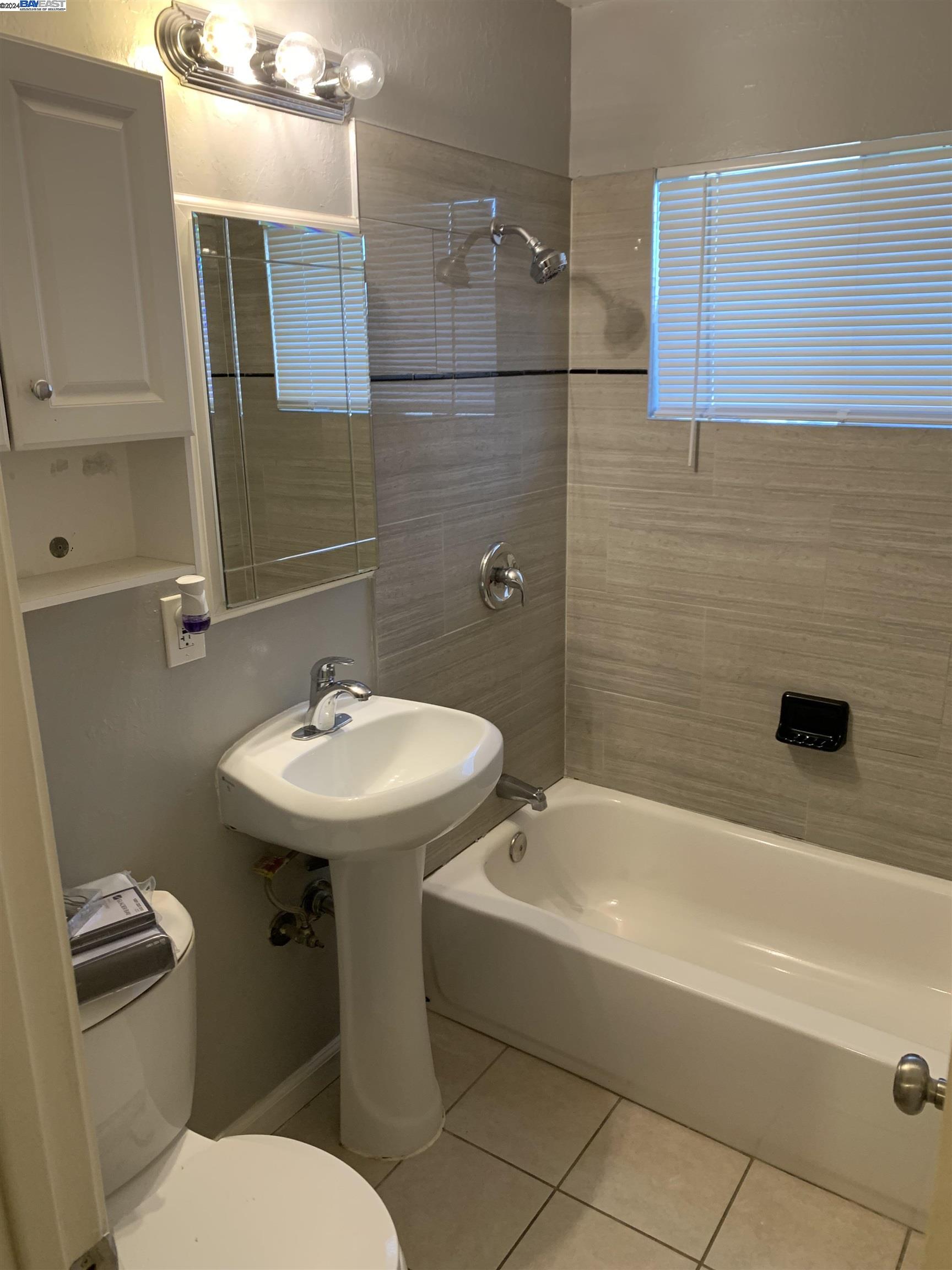 26730 Tyrrell Avenue Hayward, CA 94544 - Photo 15 of 26 a bathroom with a sink a toilet and bathtub