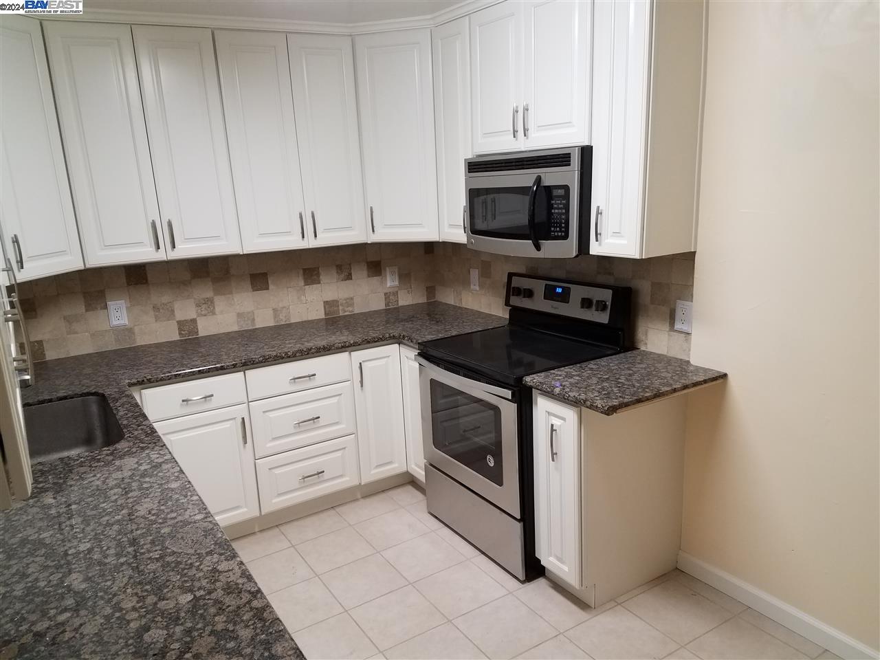26730 Tyrrell Avenue Hayward, CA 94544 - Photo 3 of 26 a kitchen with granite countertop white cabinets stainless steel appliances and sink