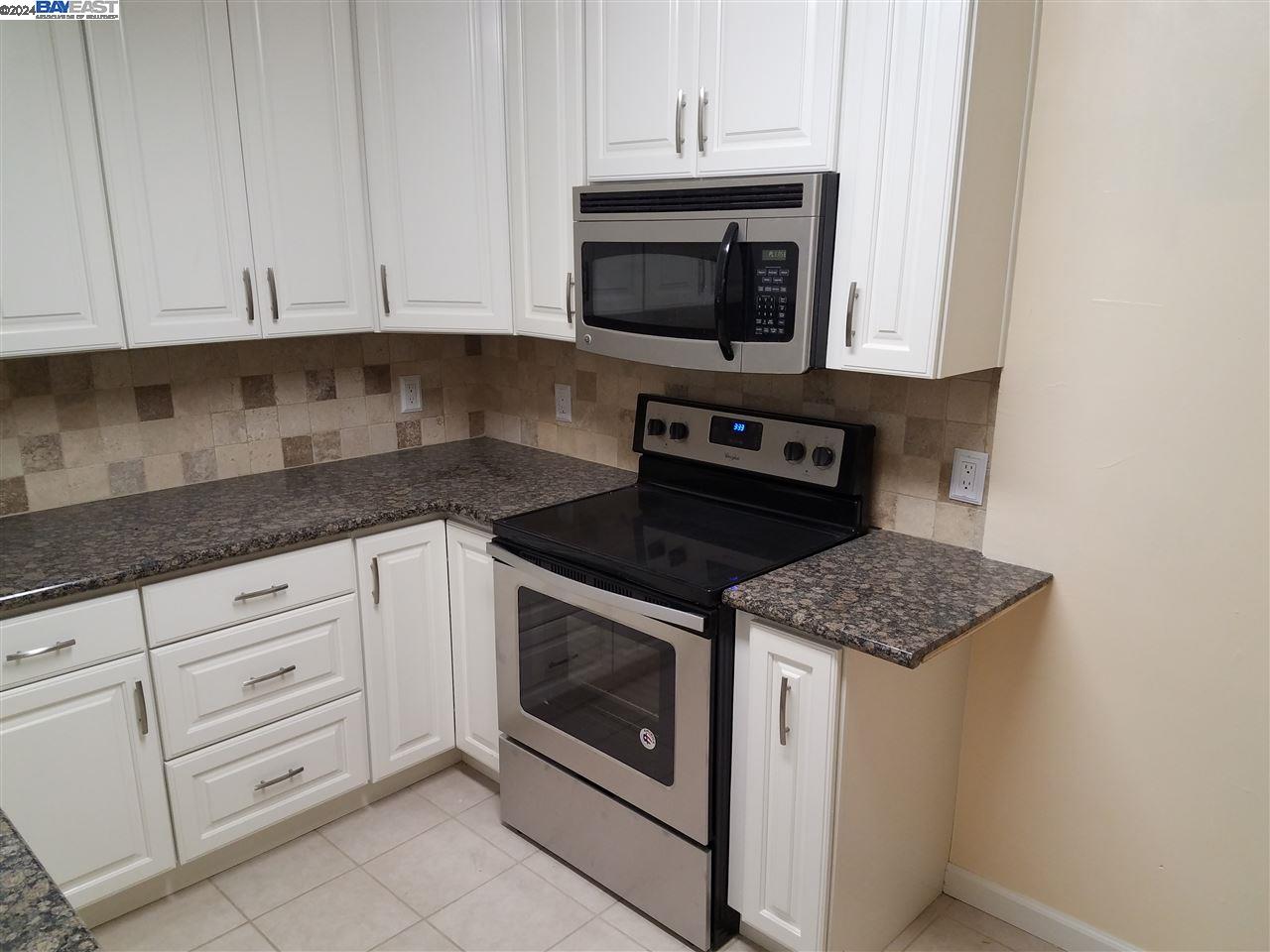 26730 Tyrrell Avenue Hayward, CA 94544 - Photo 4 of 26 a kitchen with granite countertop white cabinets stainless steel appliances and a sink