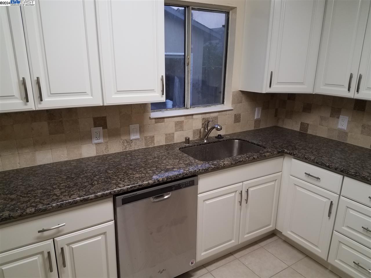 26730 Tyrrell Avenue Hayward, CA 94544 - Photo 6 of 26 a kitchen with white cabinets granite counter tops and a white stove
