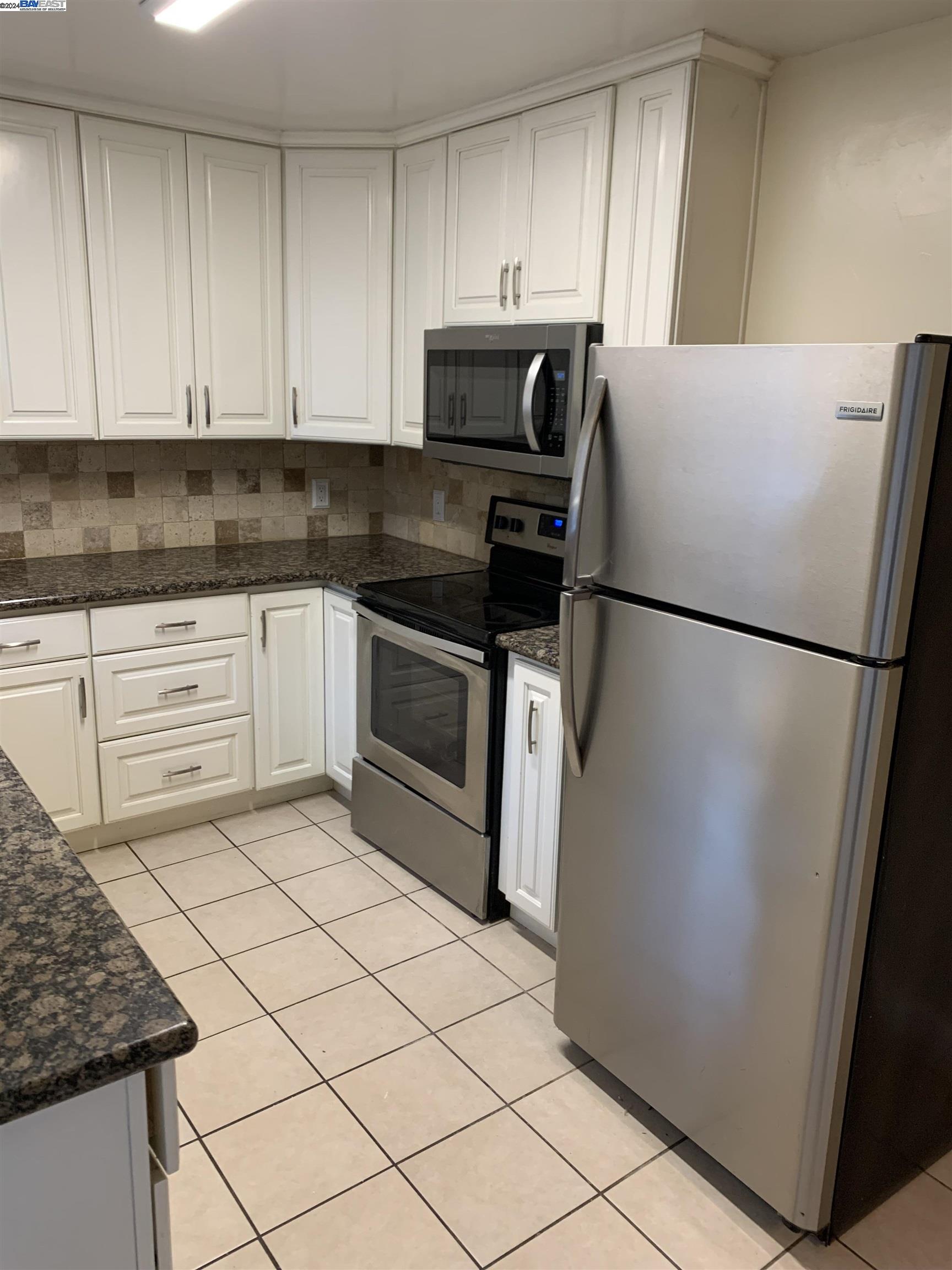 26730 Tyrrell Avenue Hayward, CA 94544 - Photo 8 of 26 a kitchen with cabinets and white stainless steel appliances