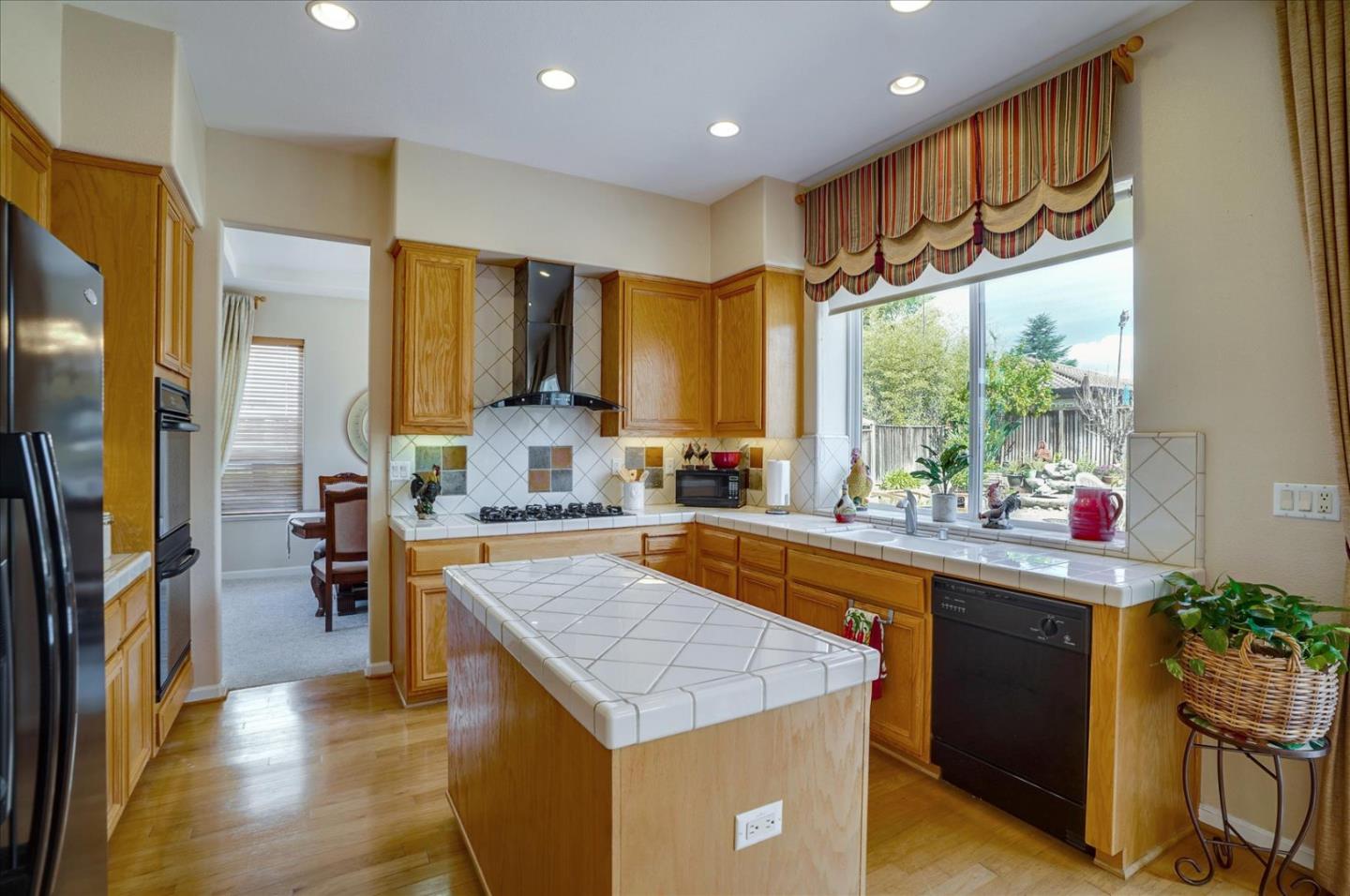 17686 Bentley Drive Morgan Hill, CA 95037 - Photo 9 of 30 a kitchen with stainless steel appliances granite countertop a sink and a refrigerator