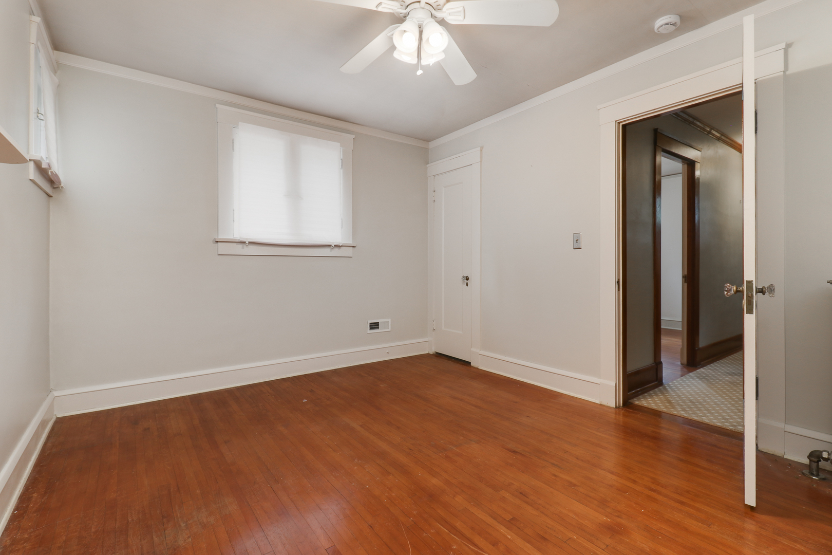 4 Clinton Place Normal, IL 61761 - Photo 23 of 38 a view of an empty room with wooden floor and a window