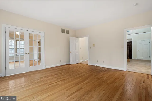 a kitchen with stainless steel appliances a sink cabinets and wooden floor
