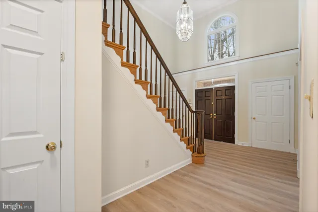 a kitchen with stainless steel appliances kitchen island granite countertop a stove top oven a sink dishwasher a refrigerator and a microwave oven with wooden floor