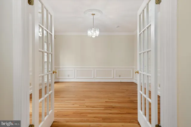 a kitchen with stainless steel appliances granite countertop a stove top oven a sink dishwasher and a refrigerator with wooden floor