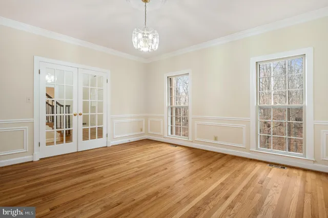 a large kitchen with stainless steel appliances kitchen island a large counter top and a stove top oven