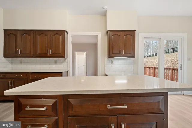 a spacious bathroom with a double vanity sink mirror and next to a window