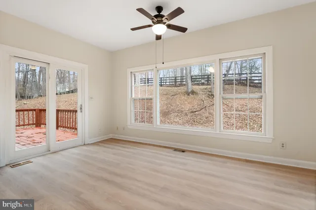 a bathroom with a granite countertop bathtub shower sink vanity and toilet
