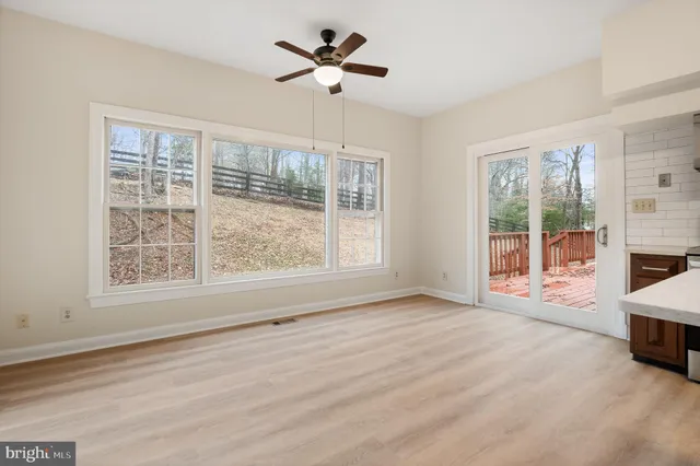 a bathroom with a granite countertop bathtub shower sink vanity and toilet