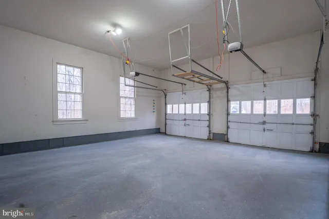 a view of a hallway with wooden floor and entryway