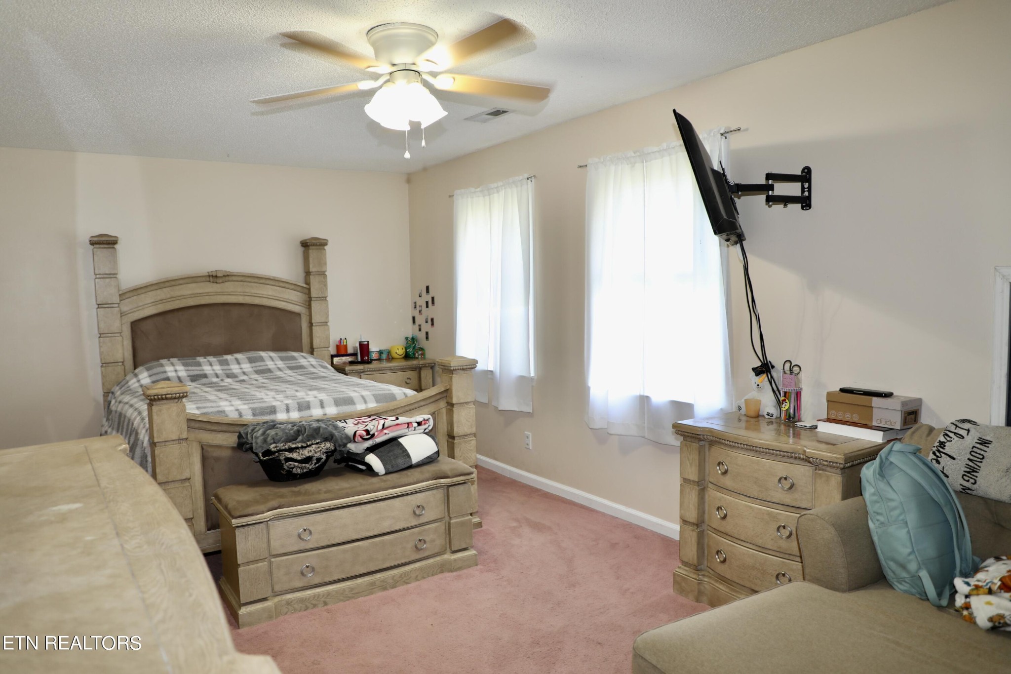 166 Donaldson Road Philadelphia, TN 37846 - Photo 16 of 42 a bedroom with a bed and a chandelier