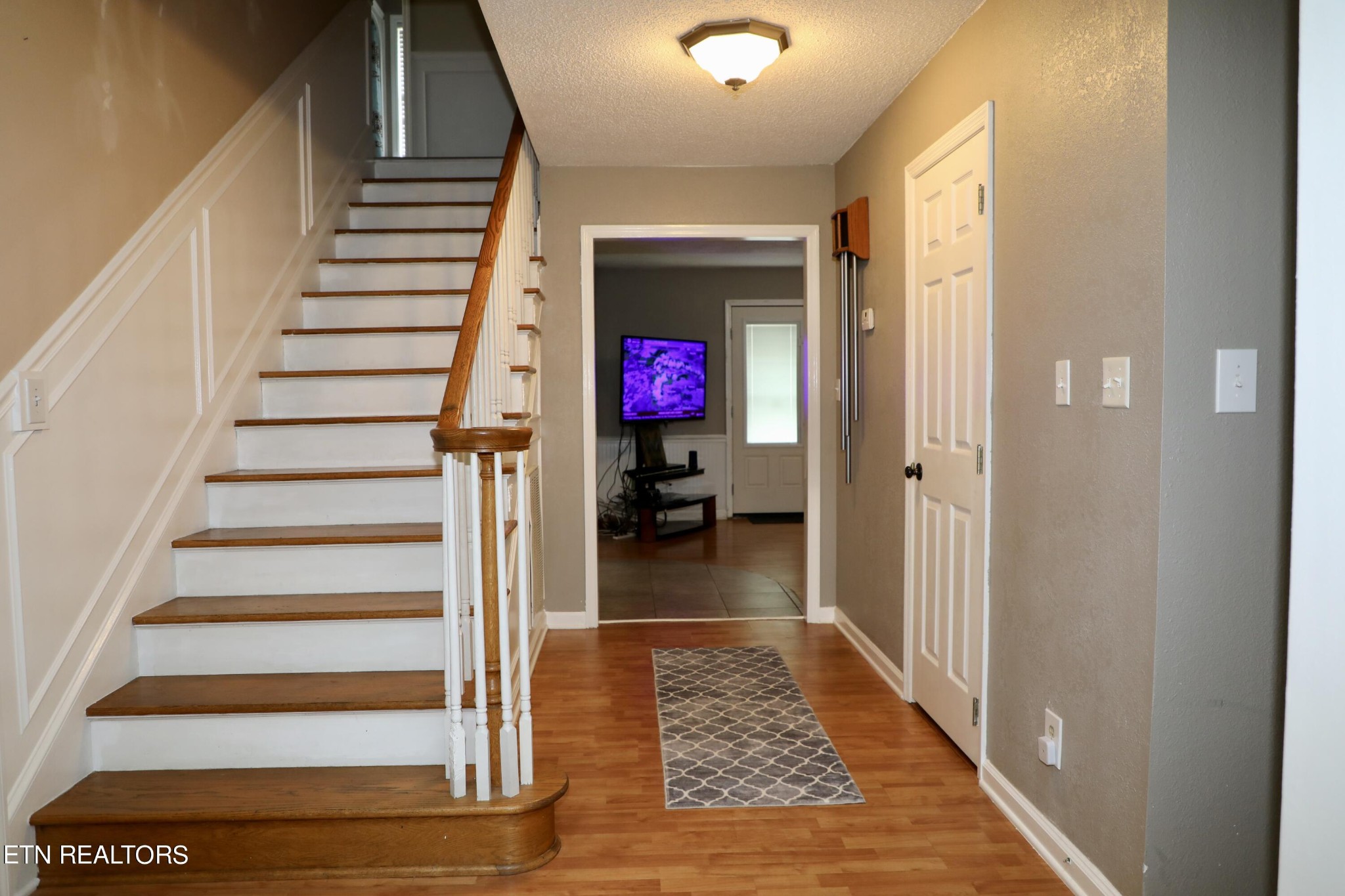 166 Donaldson Road Philadelphia, TN 37846 - Photo 3 of 42 a view of a hallway to a livingroom with wooden floor and staircase