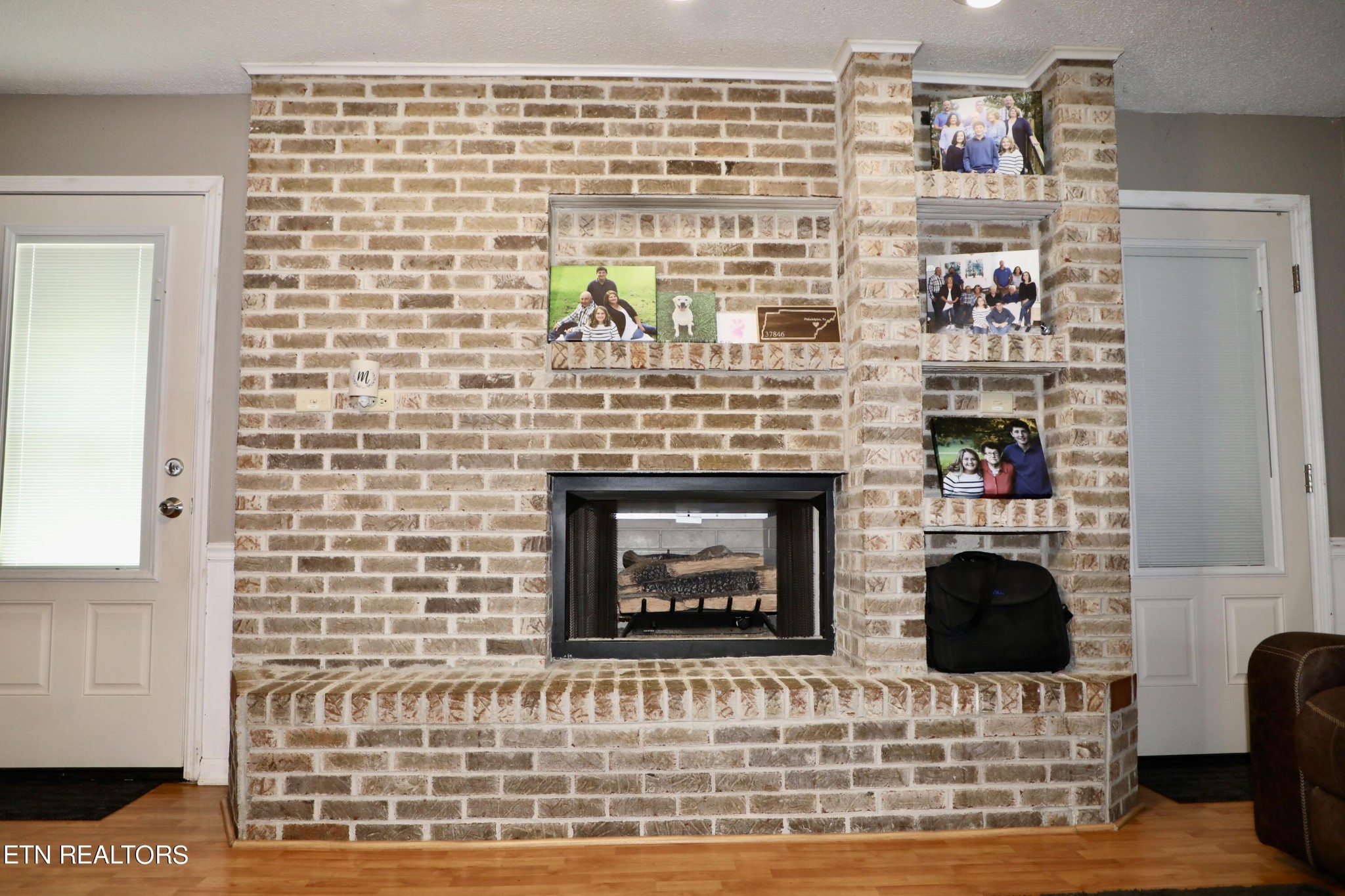 166 Donaldson Road Philadelphia, TN 37846 - Photo 6 of 42 a living room with a fireplace and a wooden floor