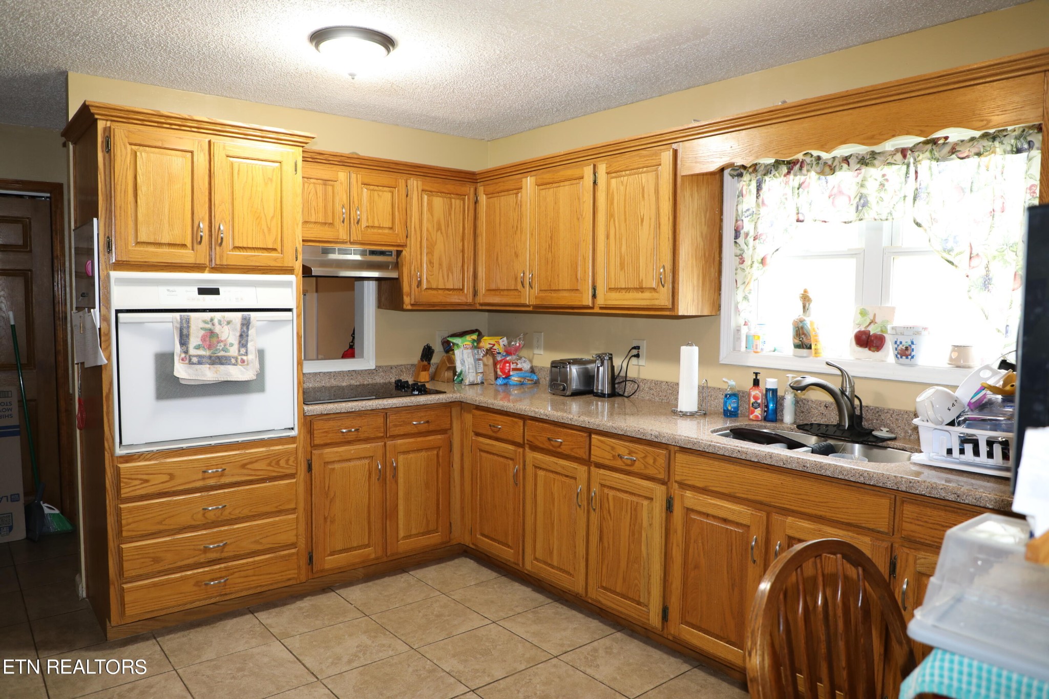 166 Donaldson Road Philadelphia, TN 37846 - Photo 7 of 42 a kitchen with granite countertop a sink stainless steel appliances and cabinets