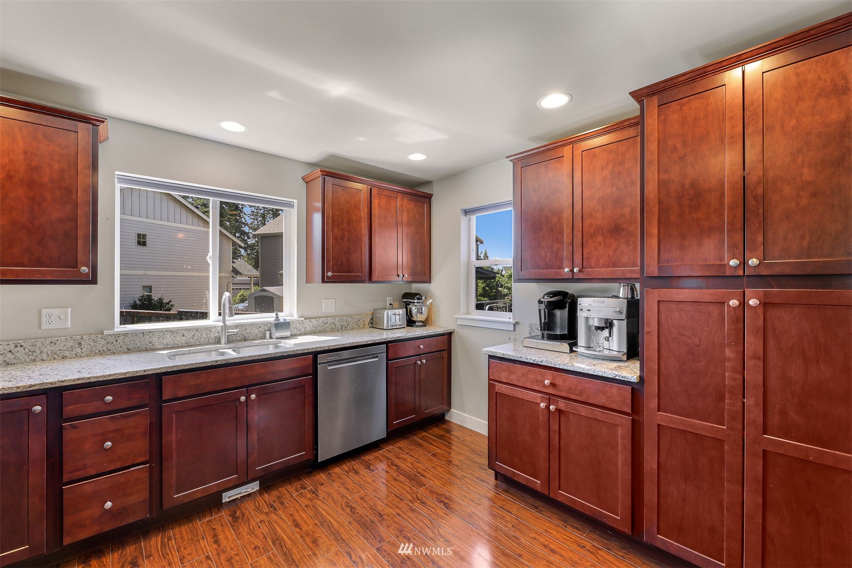 4601 Hall Road Blaine, WA 98230 - Photo 18 of 39 a kitchen with stainless steel appliances granite countertop wooden cabinets a sink and dishwasher with wooden floor