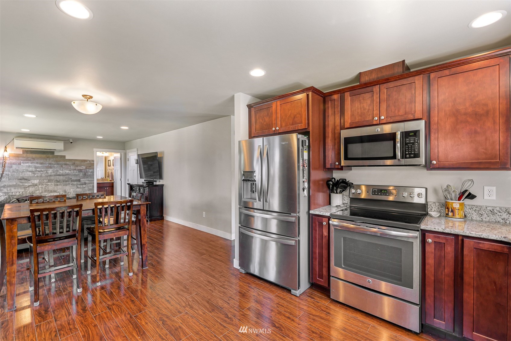 4601 Hall Road Blaine, WA 98230 - Photo 20 of 39 a kitchen with stainless steel appliances wooden floors and wooden cabinets