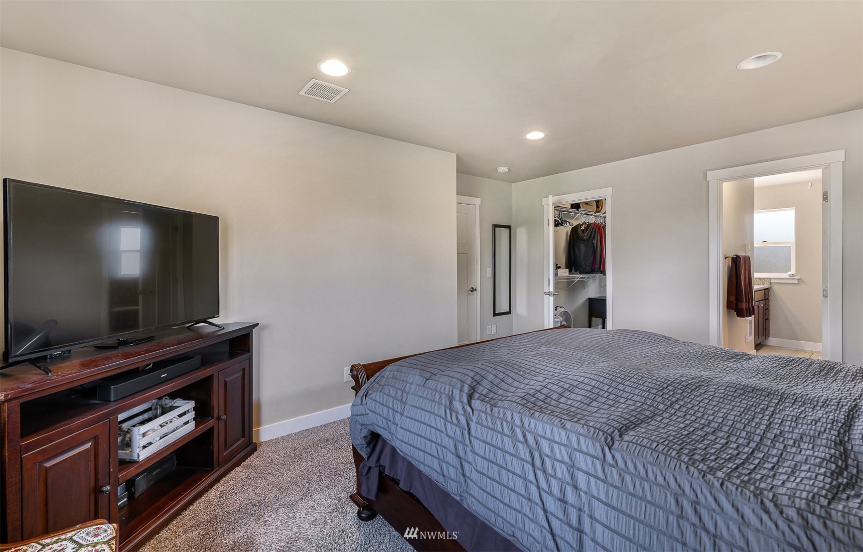 4601 Hall Road Blaine, WA 98230 - Photo 22 of 39 a bedroom with a bed and a flat screen tv