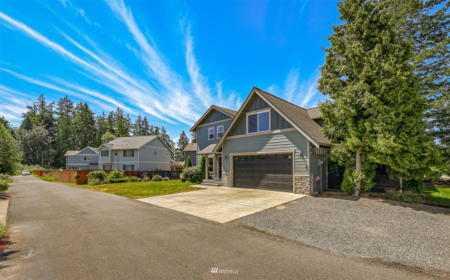 4601 Hall Road Blaine, WA 98230 - Photo 4 of 39 a front view of a house with a yard and garage