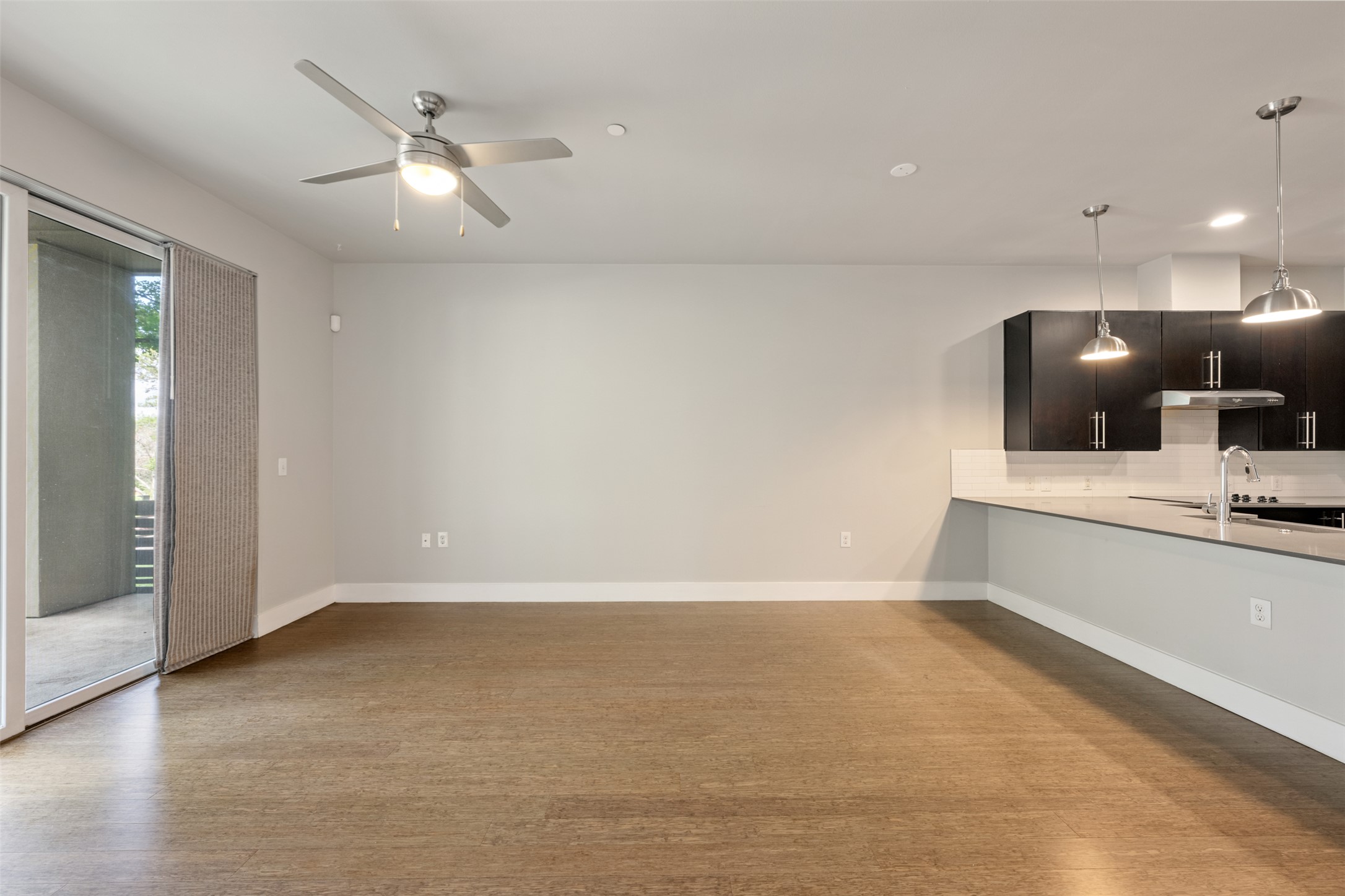 2804 Treble Lane, Unit 902 Austin, TX 78704 - Photo 17 of 31 an empty room with a chandelier fan and windows