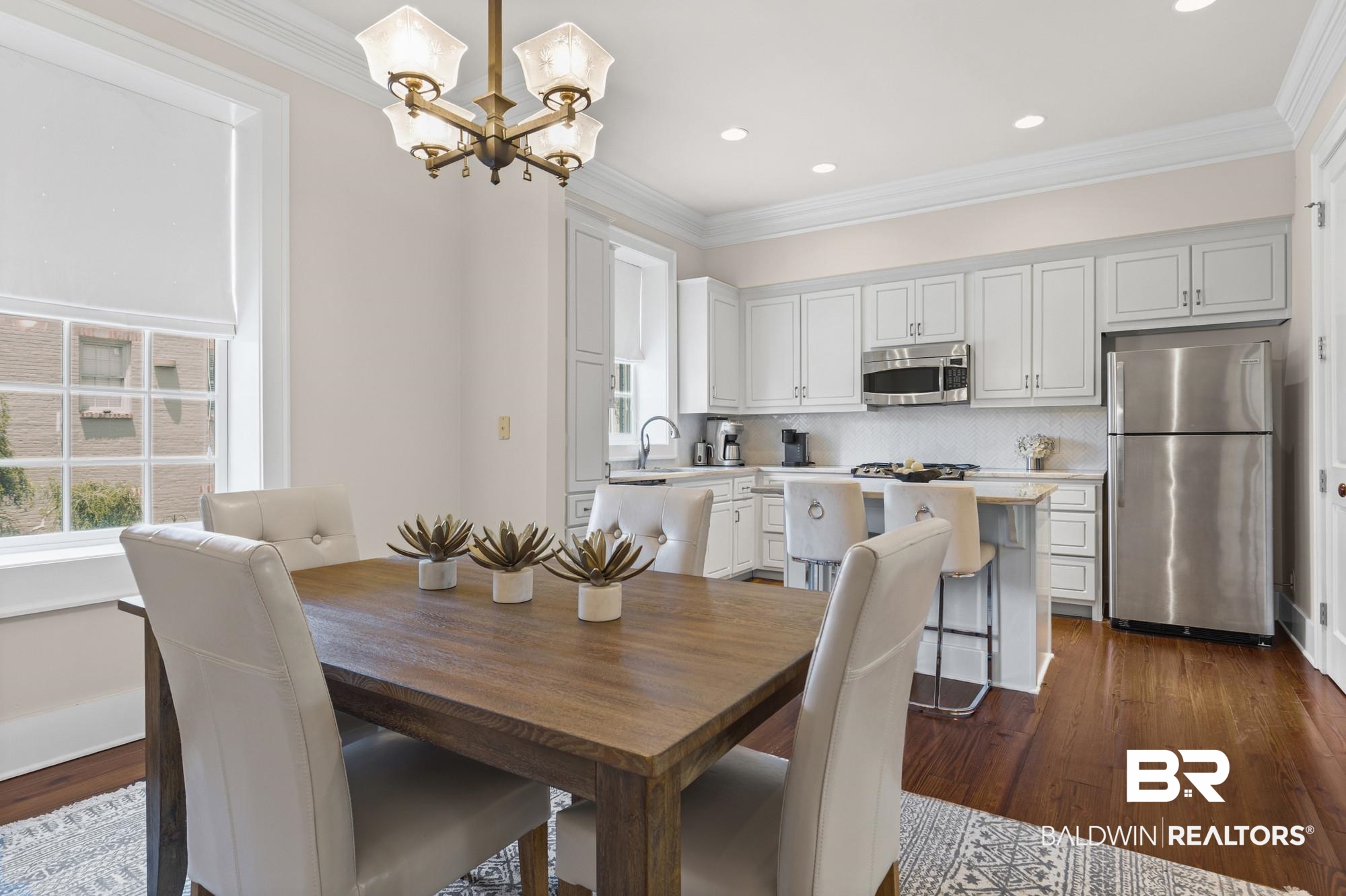 701 Dauphin Street, Unit A Mobile, AL 36602 - Photo 13 of 31 Open-concept dining area featuring wood-finish flooring and a multi-light chandelier