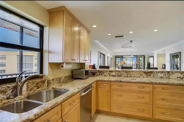 a bathroom with a granite countertop sink mirror vanity and toilet