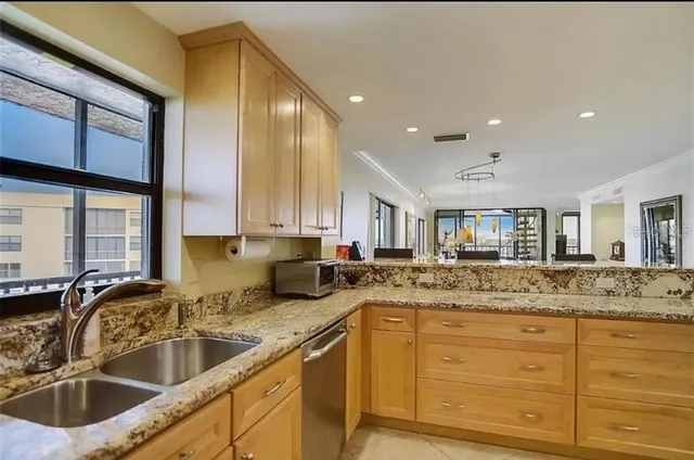 a bathroom with a granite countertop sink mirror vanity and toilet