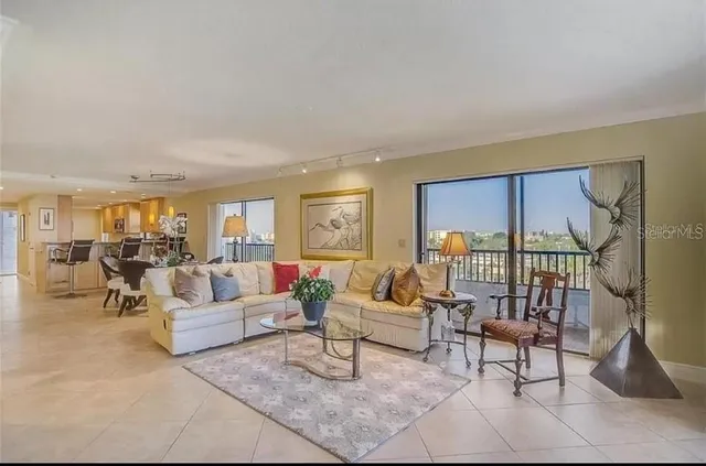 a view of kitchen with kitchen island stainless steel appliances refrigerator sink dining table and chairs