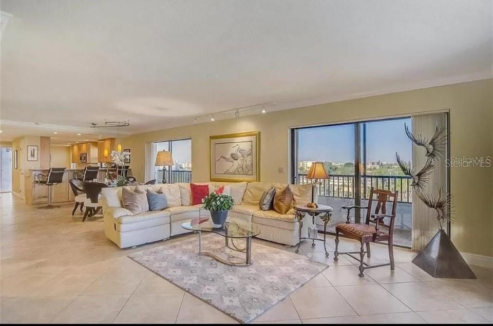5911 Midnight Pass Road, Unit 601 Sarasota, FL 34242 - Photo 15 of 48 a living room with furniture and a floor to ceiling window