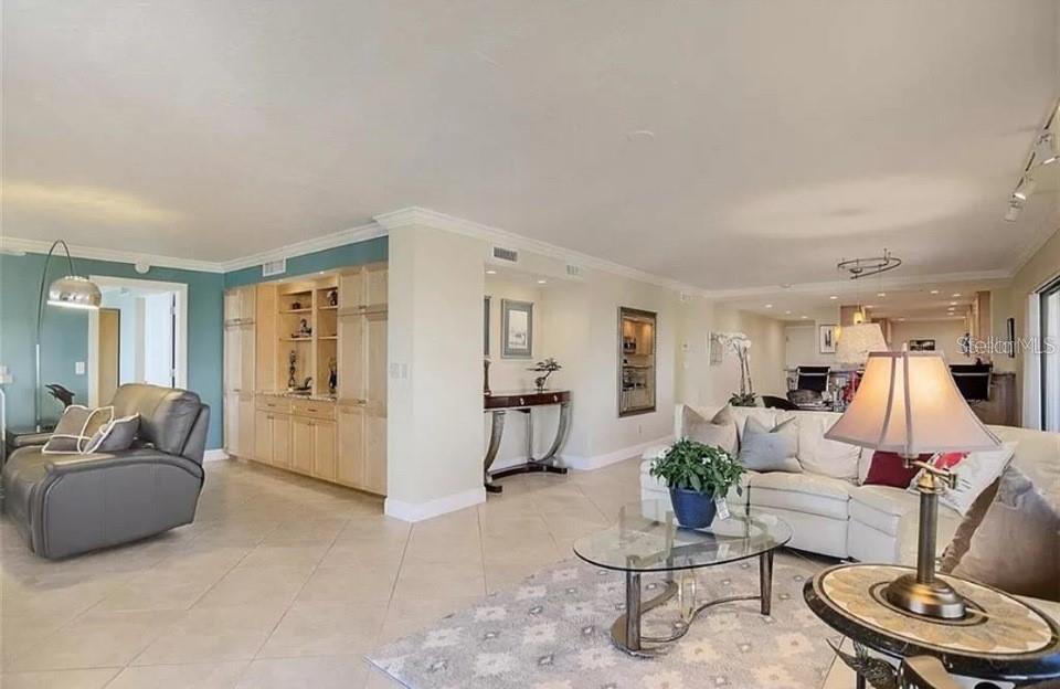 5911 Midnight Pass Road, Unit 601 Sarasota, FL 34242 - Photo 17 of 48 a living room with furniture and a wooden floor