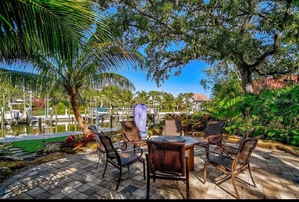 5911 Midnight Pass Road, Unit 601 Sarasota, FL 34242 - Photo 19 of 48 a view of a chairs and table in a yard