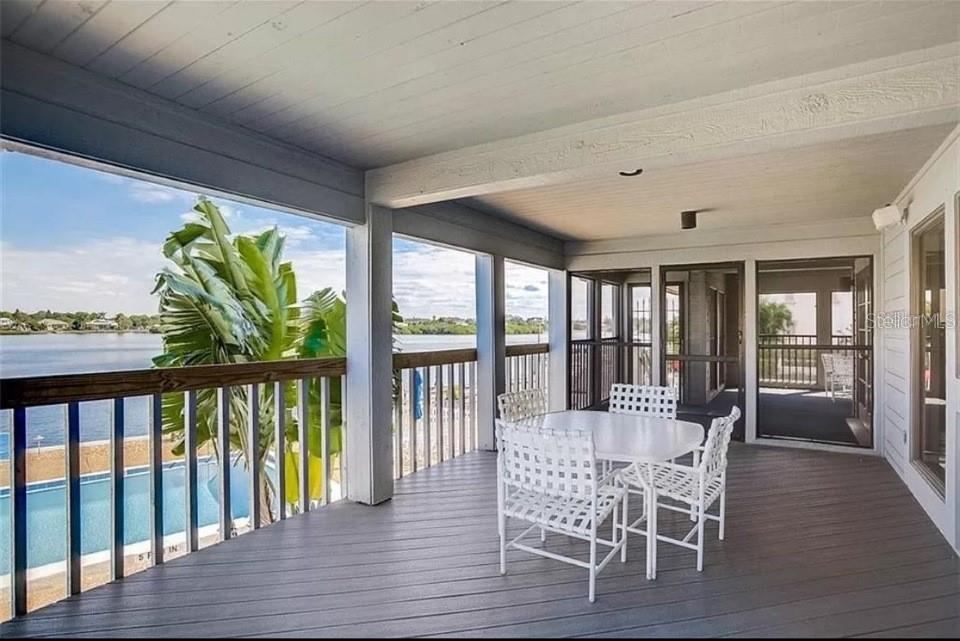 5911 Midnight Pass Road, Unit 601 Sarasota, FL 34242 - Photo 21 of 48 a view of a dining room with furniture window and wooden floor