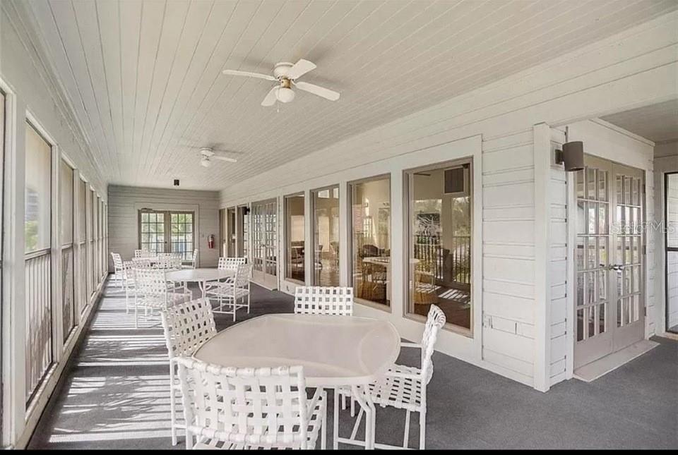 5911 Midnight Pass Road, Unit 601 Sarasota, FL 34242 - Photo 22 of 48 a living room with furniture a chandelier and a dining table