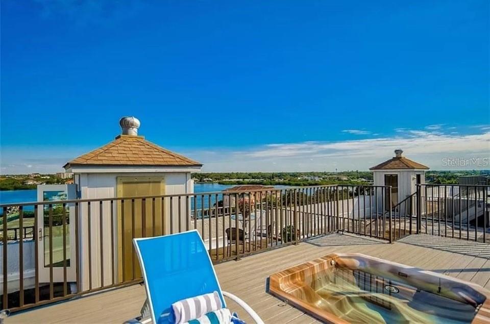5911 Midnight Pass Road, Unit 601 Sarasota, FL 34242 - Photo 23 of 48 a view of a chairs and table on the deck