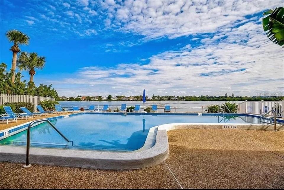 5911 Midnight Pass Road, Unit 601 Sarasota, FL 34242 - Photo 28 of 48 a view of a swimming pool with a terrace