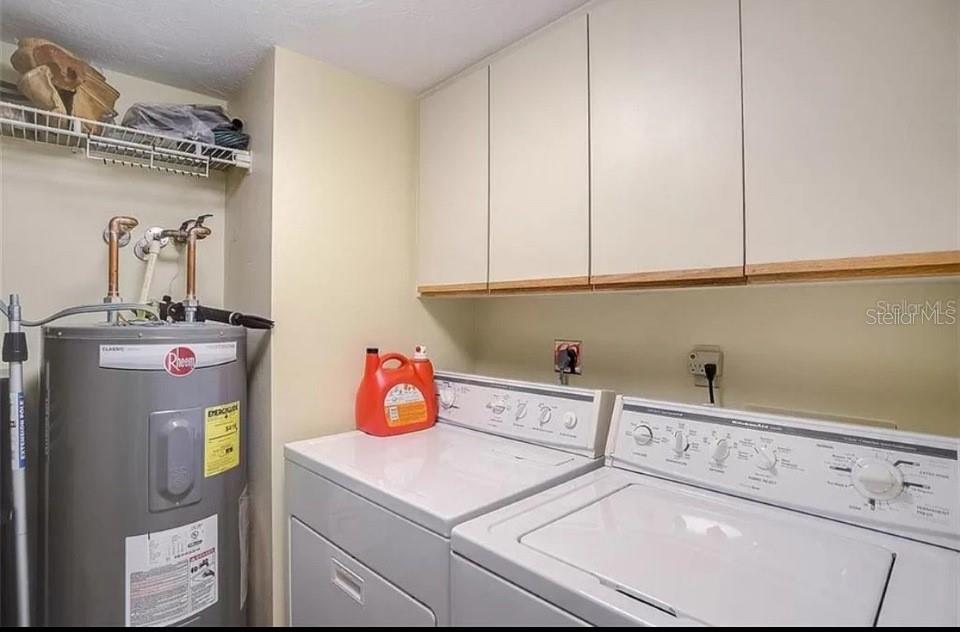 5911 Midnight Pass Road, Unit 601 Sarasota, FL 34242 - Photo 39 of 48 a utility room with dryer and washer