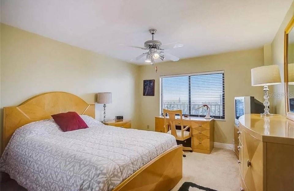 5911 Midnight Pass Road, Unit 601 Sarasota, FL 34242 - Photo 4 of 48 a bedroom with a bed and a chandelier