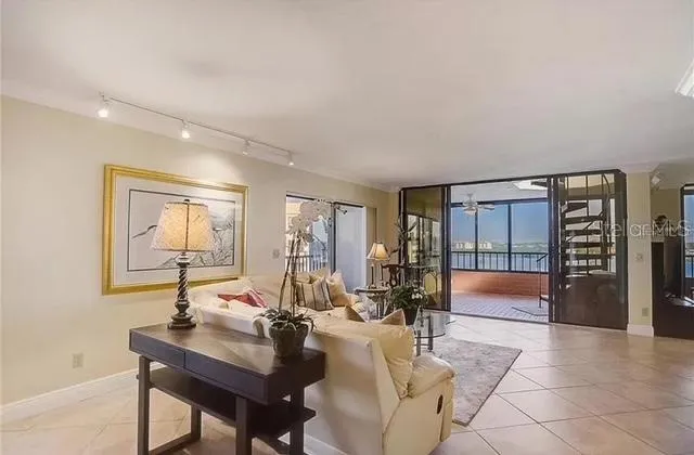 a living room with furniture and a floor to ceiling window