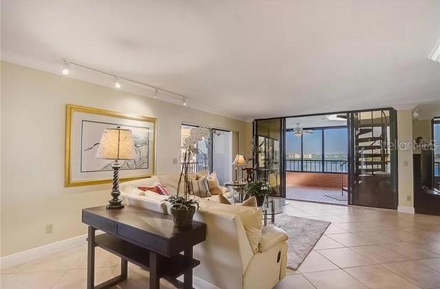 5911 Midnight Pass Road, Unit 601 Sarasota, FL 34242 - Photo 8 of 48 a living room with furniture and a potted plant